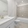 bathroom with a large mirror and ample lighting