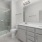 bathroom with a large mirror and ample lighting